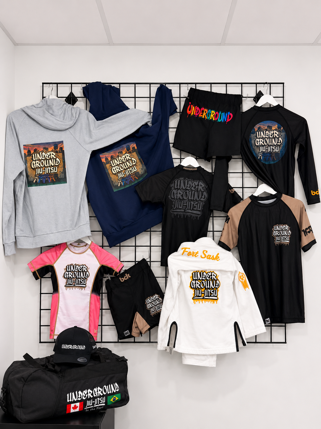 Full Underground Jiu-Jitsu merchandise wall with gis, rash guards, hoodies, shorts and bag