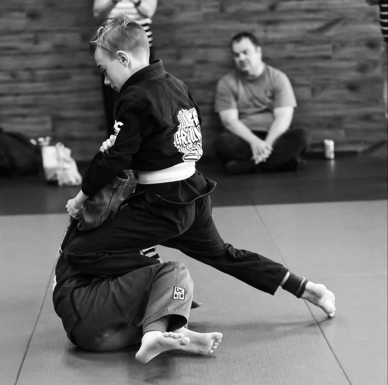 Kids martial arts students grappling during a Jiu-Jitsu class in Fort Saskatchewan